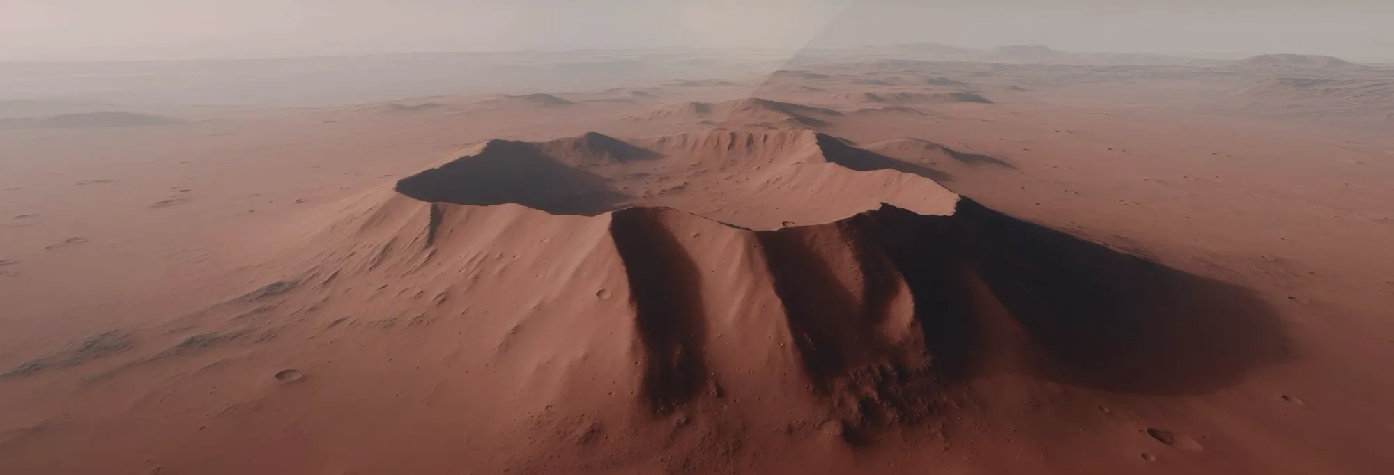 A wide crater on Mars under a pale sky.
