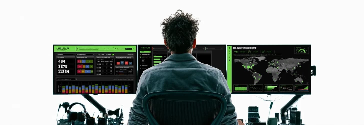 An operator at a desk faces a row of screens with telemetry and maps.
